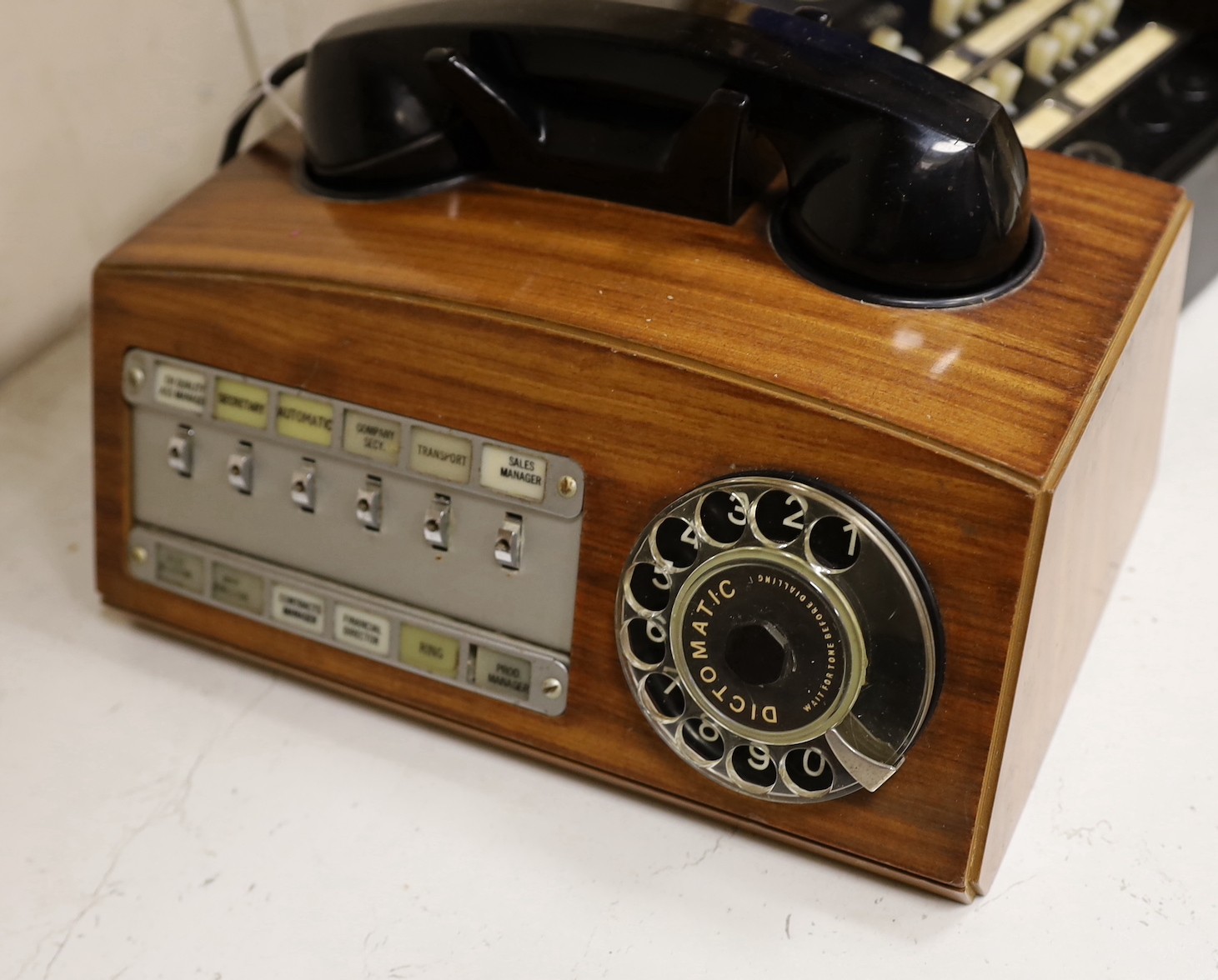 A 'switchboard' type Bakelite telephone together with two wooden cased examples (3)